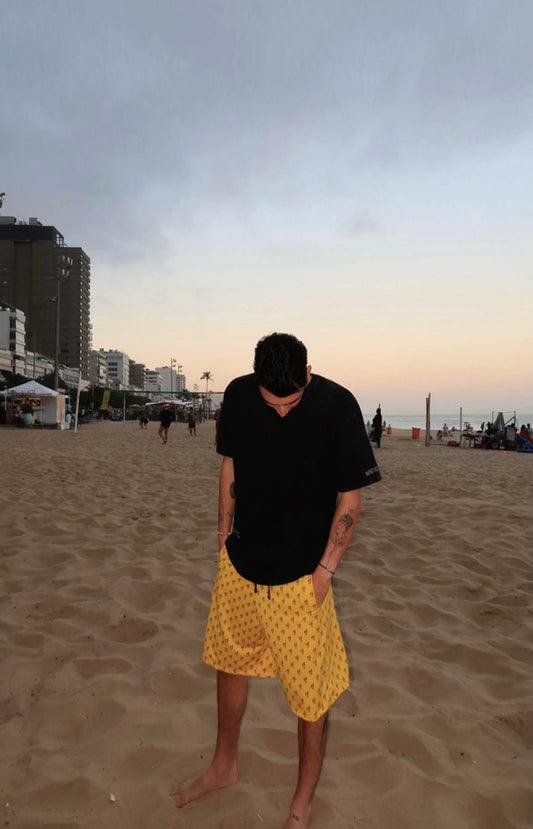 Yellow Bermuda-shorts with black snakes pattern