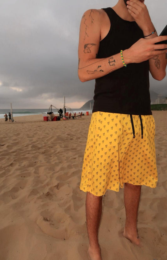 Yellow Bermuda-shorts with black snakes pattern